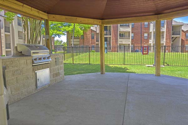 Covered gazebo near pet park with a community grill available.